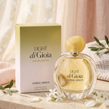 Giorgio Armani Light di Gioia Eau de Parfum 3.4oz / 100ml perfume bottle and matching box displayed in an elegant setting with white flowers and olive branches.
