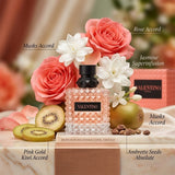 "A perfume bottle labeled 'Born in Roma Donna Coral Fantasy' by Valentino, styled with pink roses, white flowers, kiwi, and other fragrance ingredients against a warm pink and golden background with soft lighting."
