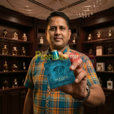 Perfumes Stop owner holding a bottle of Versace Eros Eau de Toilette 3.4oz / 100ml for Men inside a perfume store.