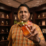 "Perfumes Stop owner holding a bottle of Bharara Beauty Fantasy Pour Femme EDP Spray 3.4oz / 100ml."
