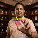 "Perfumes Stop owner holding a bottle of Bharara Beauty Grace Pour Femme EDP Spray 3.4oz / 100ml."