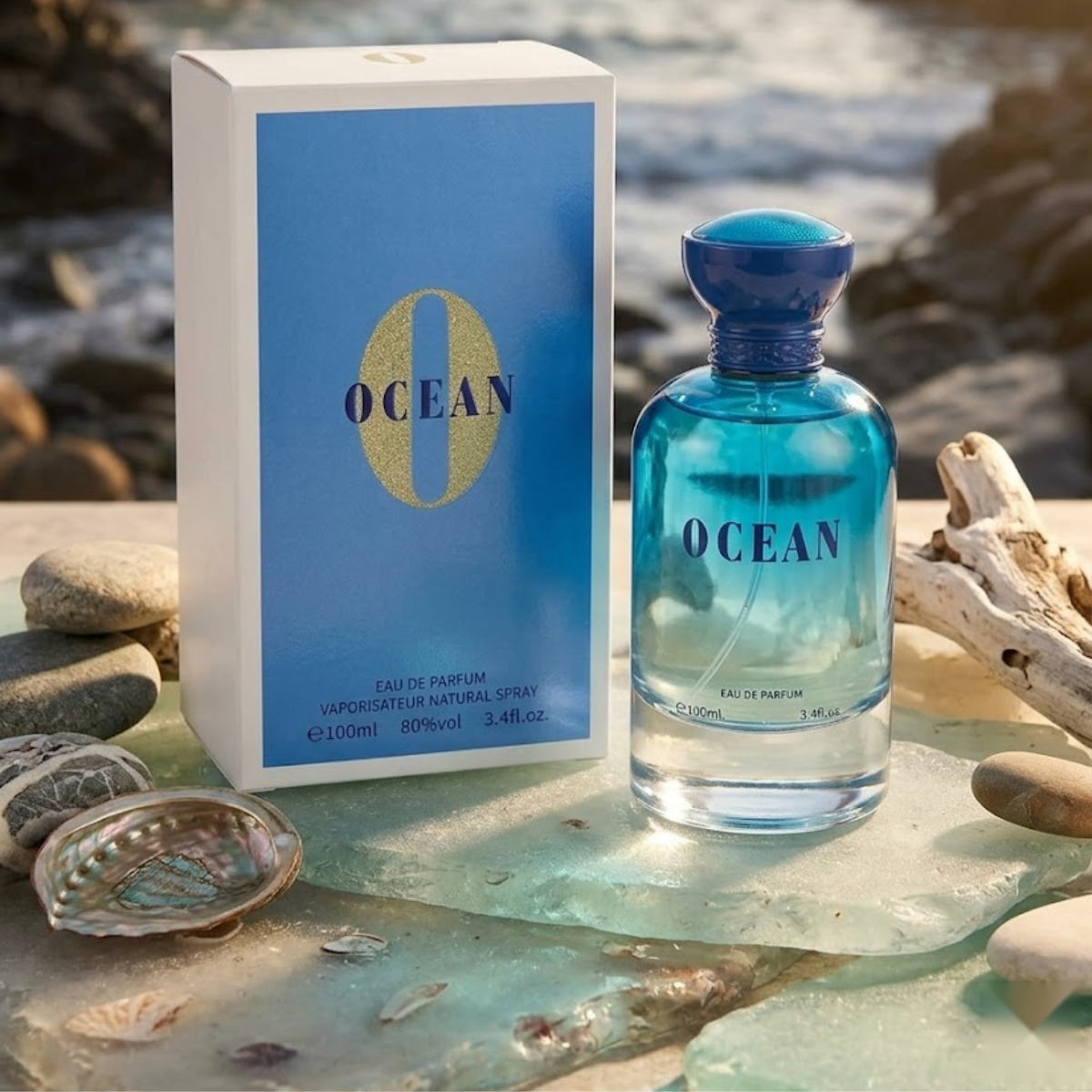 "Bharara Beauty Ocean for Men EDP Spray 3.4oz / 100ml blue perfume bottle and matching branded box displayed on a beach with seashells."
