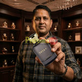 "Perfumes Stop owner holding a bottle of Bharara Beauty Tonka for Men EDP Spray 3.4oz / 100ml."