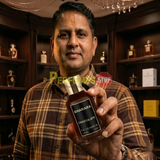 "Perfumes Stop owner holding a bottle of Bharara Chocolate EDP Spray 100ml for Men."