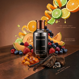 "A perfume bottle labeled 'King' by Bharara, styled with orange, bergamot, lemon, grapefruit, fruity notes, amber, vanilla, and other fragrance ingredients against a warm brown background with citrus fruits, berries, and spices."