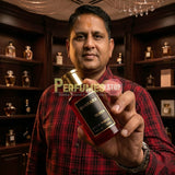 "Perfumes Stop owner holding a bottle of Bharara Queen EDP Spray 100ml."