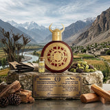 "A gold perfume bottle labeled 'Viking Kashmir' by Bharara, featuring a watch-inspired design, set against a scenic Himalayan mountain background with warm golden lighting."