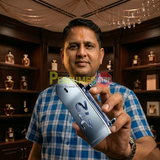 "Perfumes Stop owner holding a bottle of Carolina Herrera 212 MEN HEROES FOREVER YOUNG EDT Spray 3.0oz / 90ml."