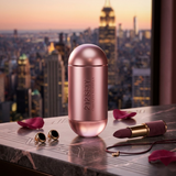 "Carolina Herrera 212 Sexy EDP Spray 3.4oz / 100ml pink perfume bottle displayed in an elegant city setting."