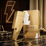 "Carolina Herrera New York Bad Boy Gold Fantasy EDT Spray 3.4oz / 100ml perfume bottle and matching gold box."