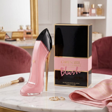 "Carolina Herrera New York Good Girl Blush EDP Spray 2.7oz / 80ml perfume bottle and matching black and pink box displayed in an elegant setting."