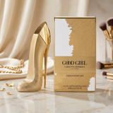 "Carolina Herrera New York Good Girl Gold Fantasy EDP Spray 2.7oz / 80ml perfume bottle and matching gold and white box displayed in an elegant setting."