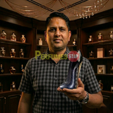 "Perfumes Stop owner holding a bottle of Carolina Herrera New York Good Girl Suprême EDP Spray 2.7oz / 80ml for Women."