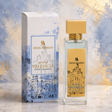 "A bottle of Creed Millesime Imperial Eau de Parfum with its matching white and blue packaging box, set against an elegant blue and white background with architectural details and soft lighting."