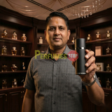 "Perfumes Stop owner holding a bottle of Emporio Armani He Cologne for Men EDT Spray 3.4oz / 100ml."