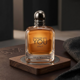 "Emporio Armani Stronger With You Only EDT Spray 3.4oz / 100ml amber perfume bottle displayed in an elegant decorative setting."