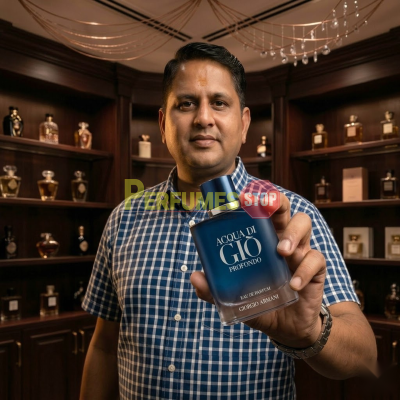 "Perfumes Stop owner holding a bottle of Giorgio Armani Acqua di Gio Profondo EDP Spray 4.2oz / 125ml."