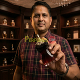 "Perfumes Stop owner holding a bottle of Jean Paul Gaultier La Belle Le Parfum Eau de Parfum Intense"