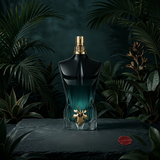 "Jean Paul Gaultier Le Beau Le Parfum EDP Intense perfume bottle displayed in a dark green decorative setting."