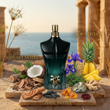 "Jean Paul Gaultier Le Beau Le Parfum perfume bottle displayed with flowers, fruits and decorative fragrance ingredients."