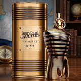 "Jean Paul Gaultier Le Male Elixir Parfum Spray 2.5 oz / 75ml gold perfume bottle and matching gold cylindrical box."