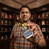 "Perfumes Stop owner holding a bottle of Jean Paul Gaultier Scandal EDT Pour Homme Spray 3.4oz / 100ml."