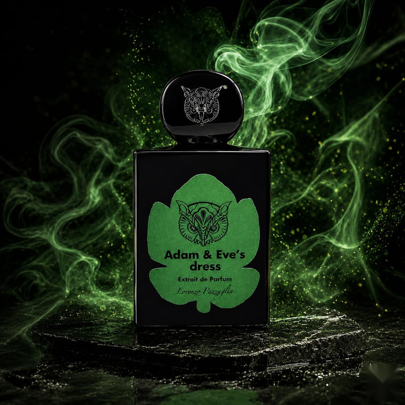 "A black perfume bottle labeled 'Adam & Eve's Dress' by Lorenzo Pazzaglia, featuring a green label and cap, set against a dramatic dark green background with swirling smoke and soft lighting."