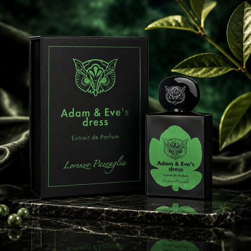 "A bottle of Lorenzo Pazzaglia Adam & Eve's Dress Extrait de Parfum with its matching black and green packaging box, featuring a green botanical graphic, set against a dark green background with soft lighting."
