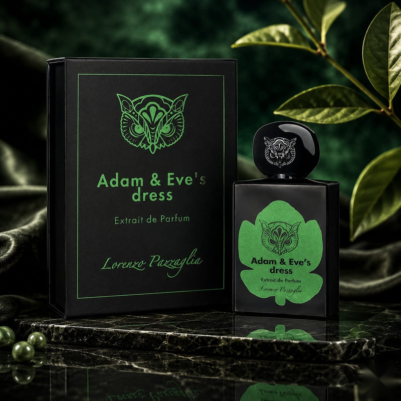 "A bottle of Lorenzo Pazzaglia Adam & Eve's Dress Extrait de Parfum with its matching black and green packaging box, featuring a green botanical graphic, set against a dark green background with soft lighting."