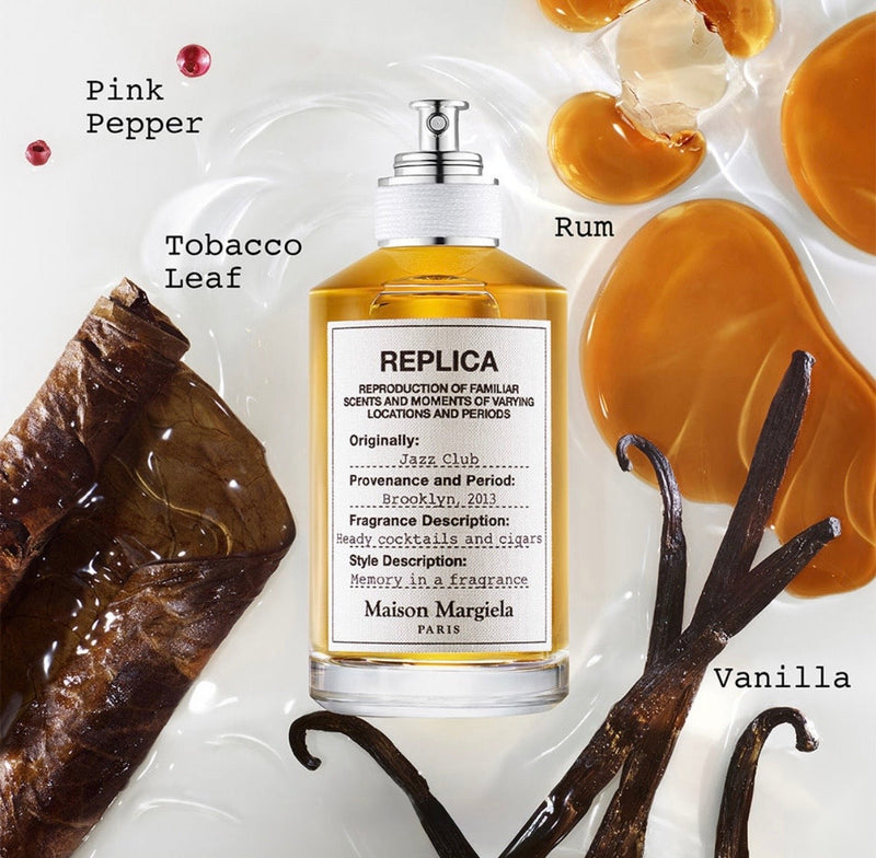 "A perfume bottle labeled 'Replica Jazz Club' by Maison Margiela, styled with pink pepper, neroli, rum, sage, tobacco leaf, and vanilla against a warm background with citrus fruits, spices, and soft lighting."
