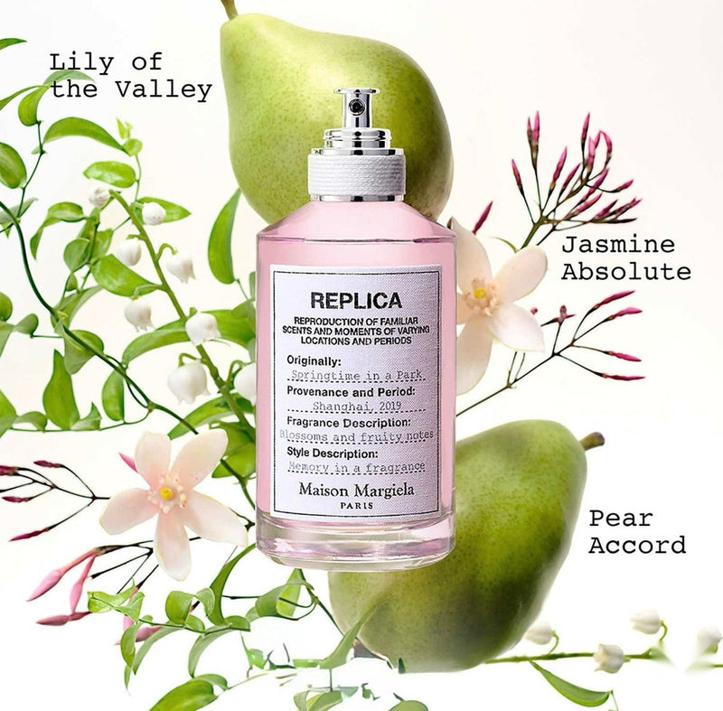 "A perfume bottle labeled 'Replica Springtime in a Park' by Maison Margiela, styled with pear, bergamot, blackcurrant, lily of the valley, rose damascena, musk, and vanilla against a bright spring garden background with green leaves, white flowers, and soft natural lighting."