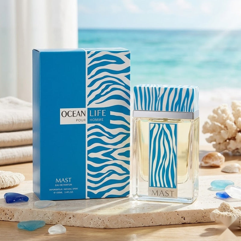 "Mast Ocean Life Pour Homme perfume bottle and blue branded box displayed with citrus fruits and fragrance ingredients."