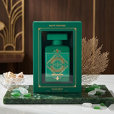 "Mast Parfume Ocean Green perfume bottle surrounded by green foliage, flowers, spices and fragrance ingredients."
