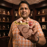 "Perfumes Stop owner holding a bottle of Mast Parfume Velvet Rose EDP Spray 3.4oz / 100ml for Women."