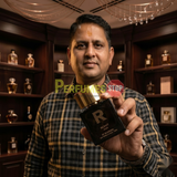 "Perfumes Stop owner holding a bottle of Rohit Noir by Bharara EDP Spray 3.4oz for Men."