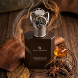 Swiss Arabian Tobacco 01 perfume bottle with a metallic silver lighter-shaped cap, styled on a dark wooden surface with a leather pad, amber liquid, star anise, and smoke effects.