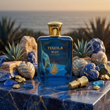 "Tequila Bleu Pour Homme EDP Spray 3.3oz / 100ml blue perfume bottle displayed with blue flowers and decorative accessories."