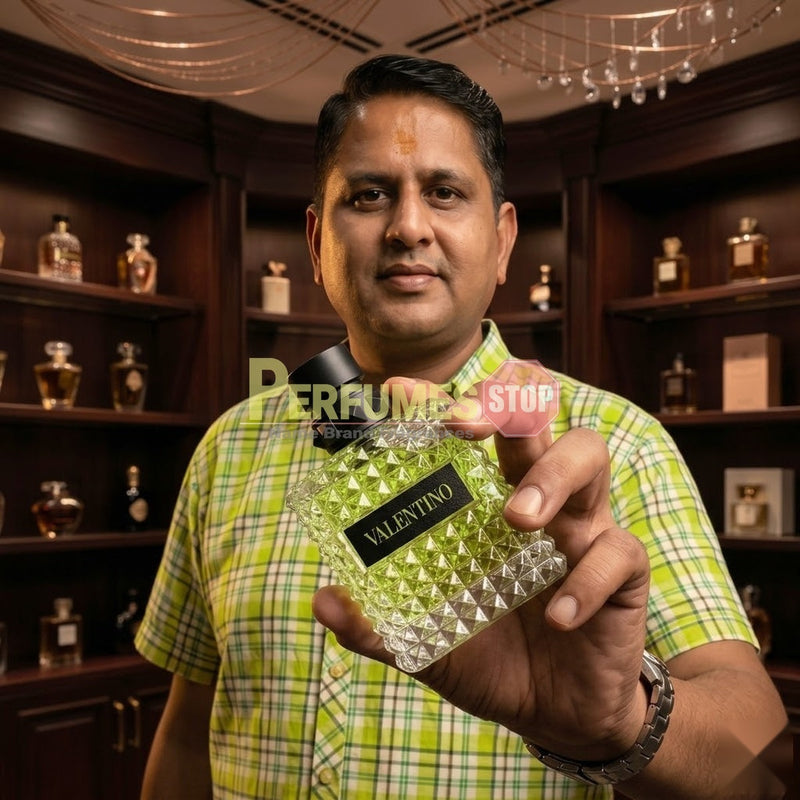 "Perfumes Stop owner holding a bottle of Valentino Born in Roma Donna Green Stravaganza Eau de Parfum"