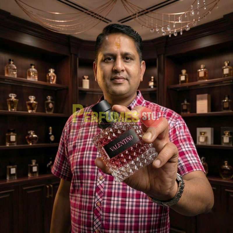 "Perfumes Stop owner holding a bottle of Valentino Born in Roma Donna Intense Eau de Parfum"