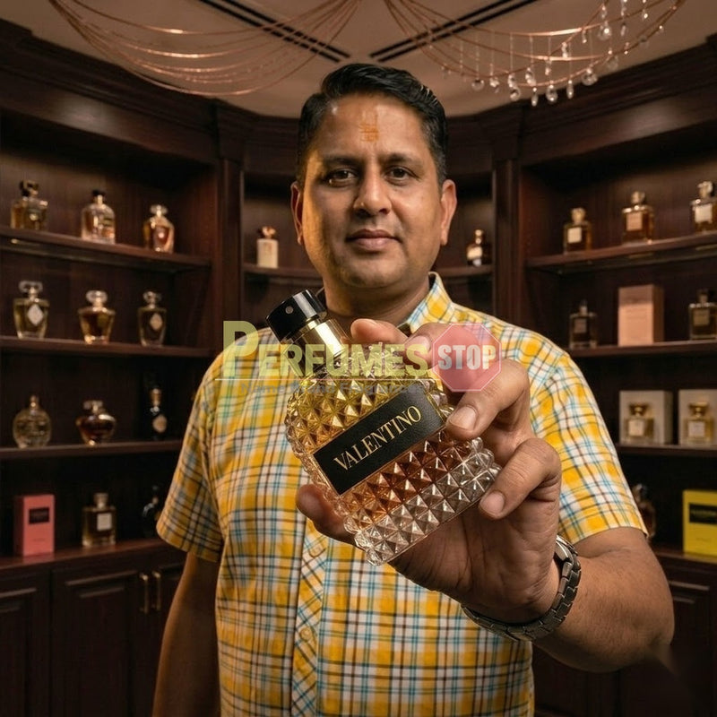 "Perfumes Stop owner holding a bottle of Valentino Born in Roma Donna Yellow Dream Eau de Parfum"