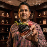 "Perfumes Stop owner holding a bottle of Valentino Born in Roma Uomo Coral Fantasy Eau de Toilette"