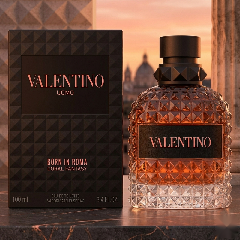 "A bottle of Valentino Born in Roma Uomo Coral Fantasy Eau de Toilette with its matching black packaging box, featuring a textured geometric design, set against a warm, elegant background with soft golden lighting."