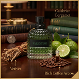 "A bottle of Valentino Born in Roma Uomo Green Stravaganza Eau de Toilette with its matching black packaging box, featuring a textured geometric design, set against a dark, elegant background with warm golden lighting."