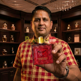 "Perfumes Stop owner holding a bottle of Versace Eros Flame EDP Spray 3.4oz / 100ml for Men."
